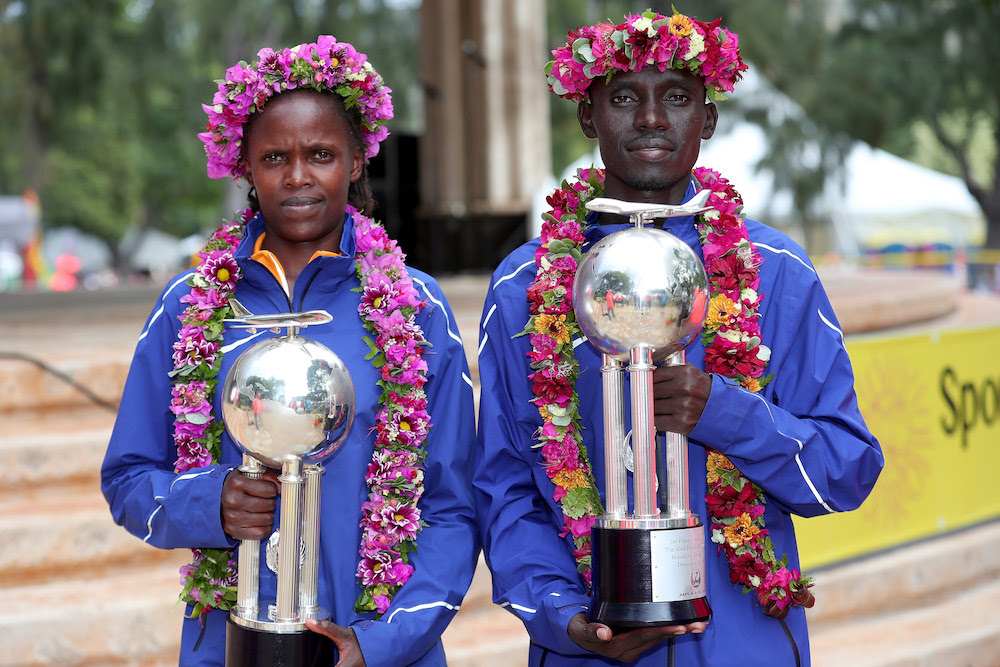 HONOLULU, HI - DECEMBER 10:  (L-R) Bridgid Kosei of Kenya and Dennis Kimetto of Kenya pose with trophies after winning the Men's and Women's divisions of the Honolulu Marathon 2017 on December 10, 2017 in Honolulu, Hawaii.  (Photo by Tom Pennington/Getty Images for HONOLULU MARATHON) *** Local Caption *** Bridgid Kosei; Dennis Kimetto