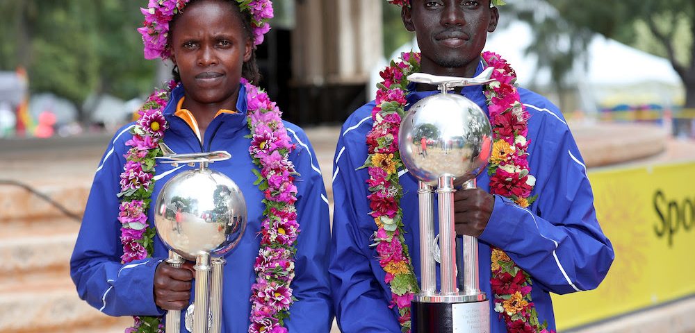 HONOLULU, HI - DECEMBER 10: (L-R) Bridgid Kosei of Kenya and Dennis Kimetto of Kenya pose with trophies after winning the Men's and Women's divisions of the Honolulu Marathon 2017 on December 10, 2017 in Honolulu, Hawaii. (Photo by Tom Pennington/Getty Images for HONOLULU MARATHON) *** Local Caption *** Bridgid Kosei; Dennis Kimetto
