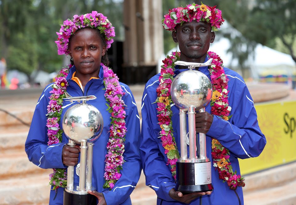 HONOLULU, HI - DECEMBER 10: (L-R) Bridgid Kosei of Kenya and Dennis Kimetto of Kenya pose with trophies after winning the Men's and Women's divisions of the Honolulu Marathon 2017 on December 10, 2017 in Honolulu, Hawaii. (Photo by Tom Pennington/Getty Images for HONOLULU MARATHON) *** Local Caption *** Bridgid Kosei; Dennis Kimetto