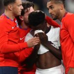 Soccer Football - Euro 2020 - Final - Italy v England - Wembley Stadium, London, Britain - July 11, 2021 England's Bukayo Saka looks dejected after losing the penalty shootout as teammates console him Pool via REUTERS/Carl Recine TPX IMAGES OF THE DAY